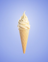 Tasty vanilla ice cream in waffle cone on pastel blue background. Soft serve