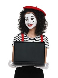 Funny mime with laptop posing on white background