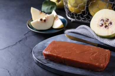Photo of Delicious quince paste served on black table