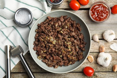 Fried minced meat and different products on wooden table, flat lay