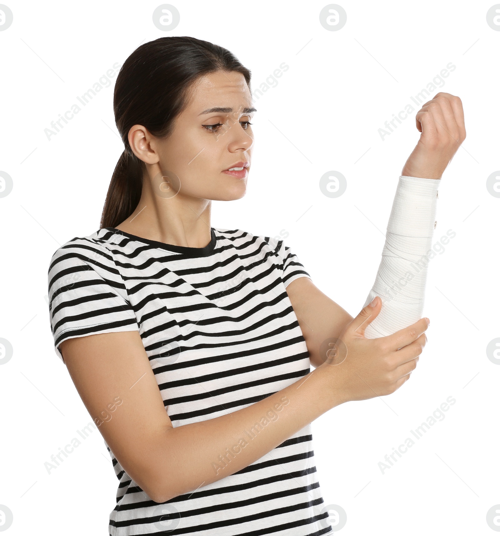 Photo of Young woman with arm wrapped in medical bandage on white background