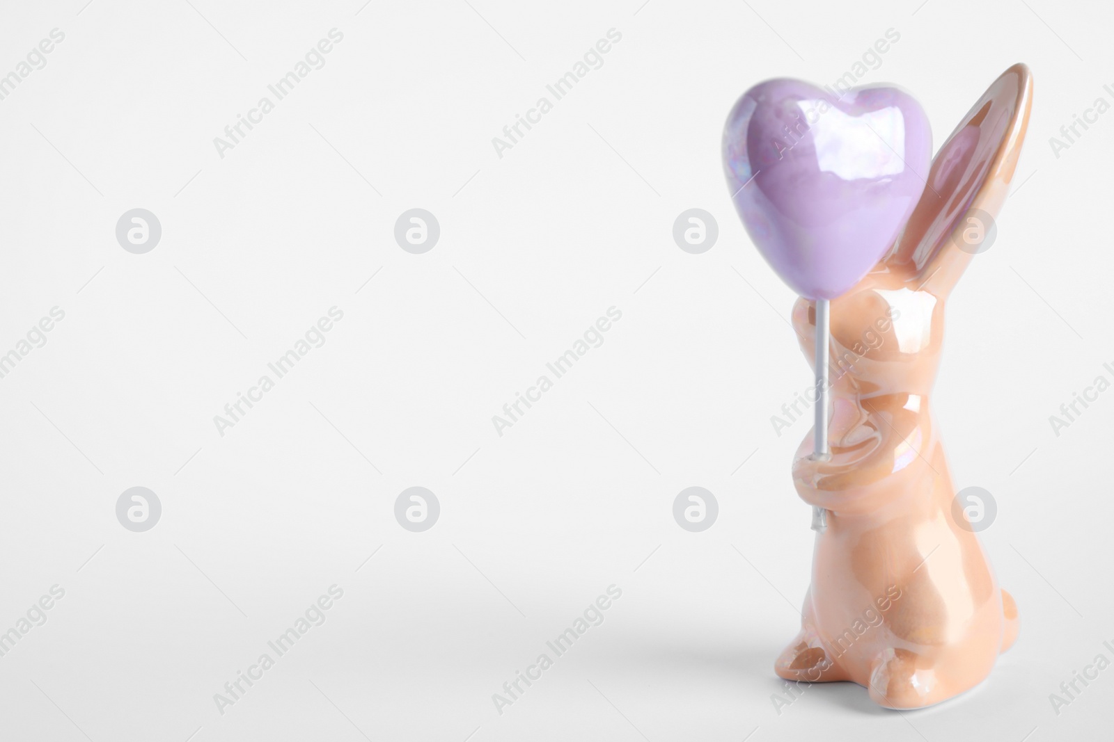 Photo of Easter bunny figure on white background. Space for text