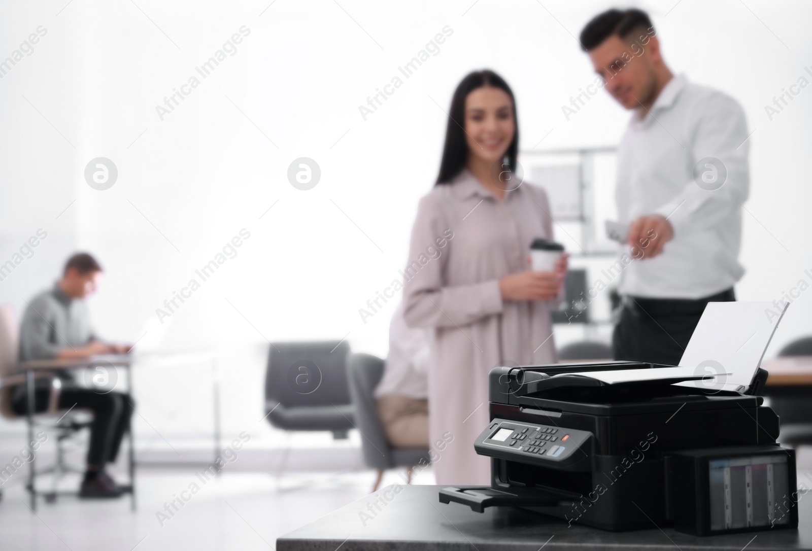 Photo of New modern printer on table in office. Space for text