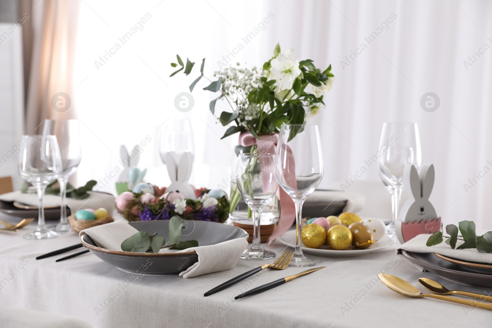 Photo of Beautiful Easter table setting with festive decor indoors