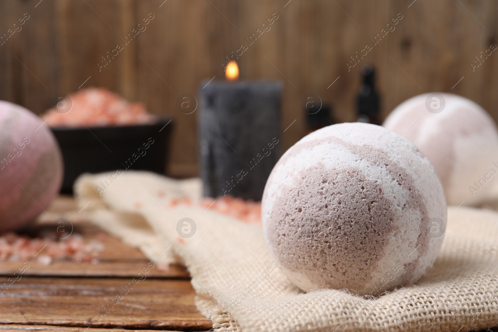 Photo of Bath bomb on wooden table, closeup. Space for text