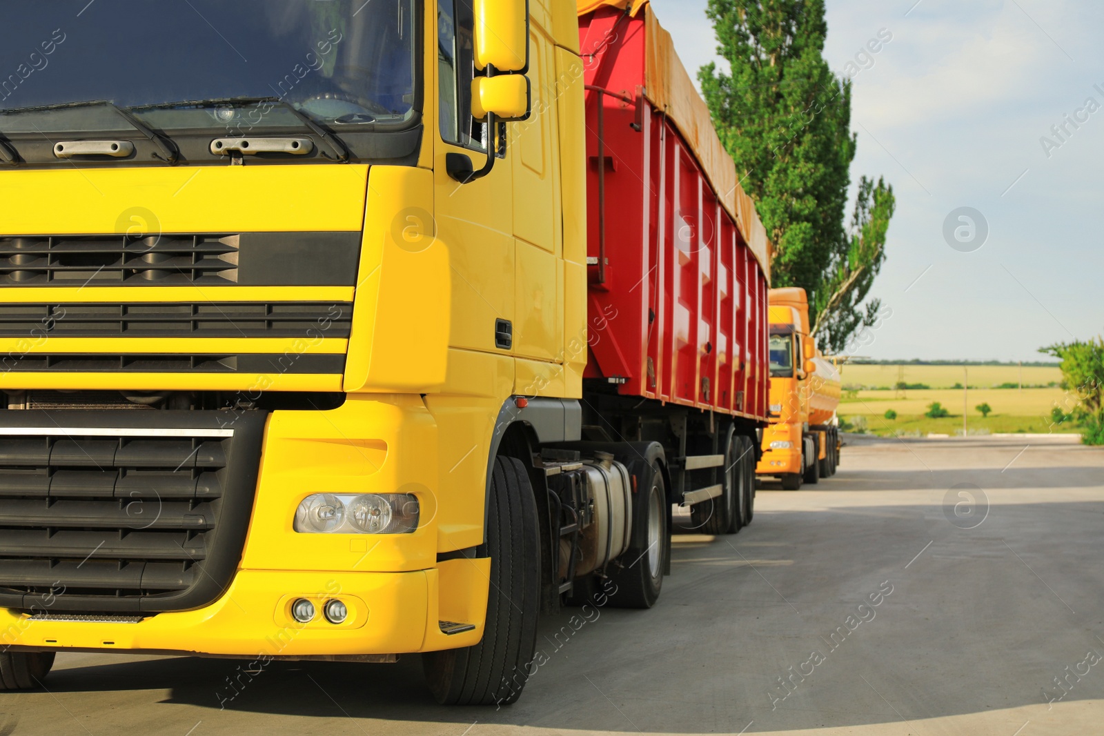 Photo of Modern bright truck on road, closeup. Space for text