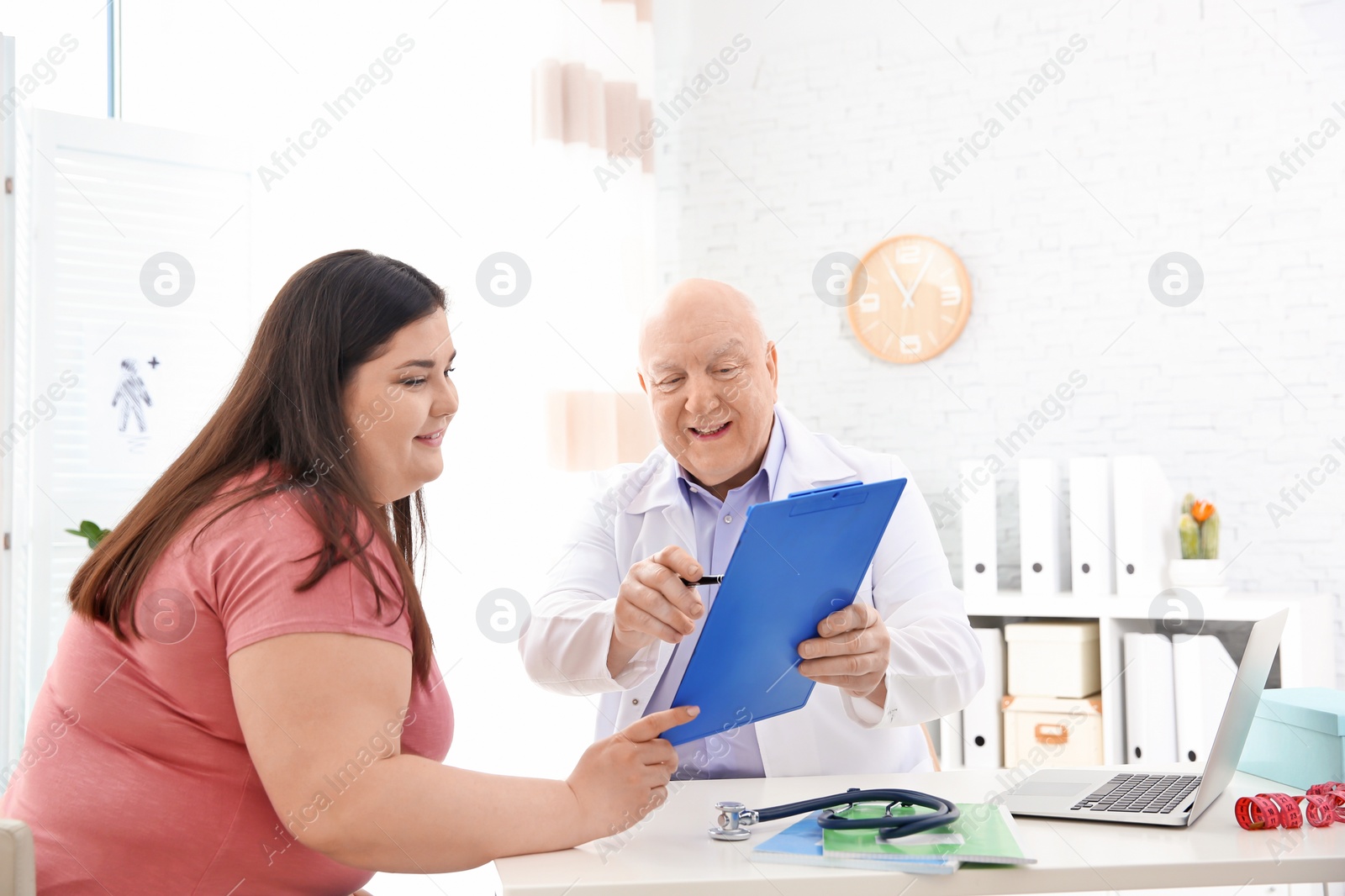 Photo of Overweight woman having consultation at doctor's office