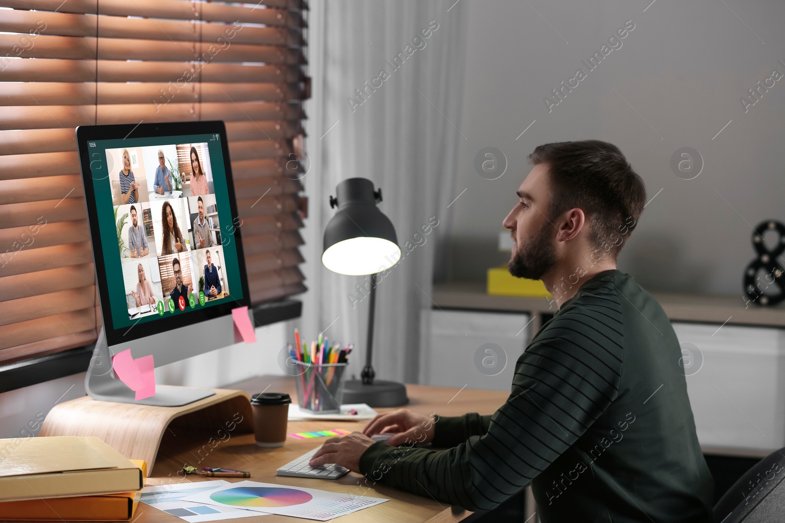 Image of Man having video chat with colleagues at table in office. Team work 