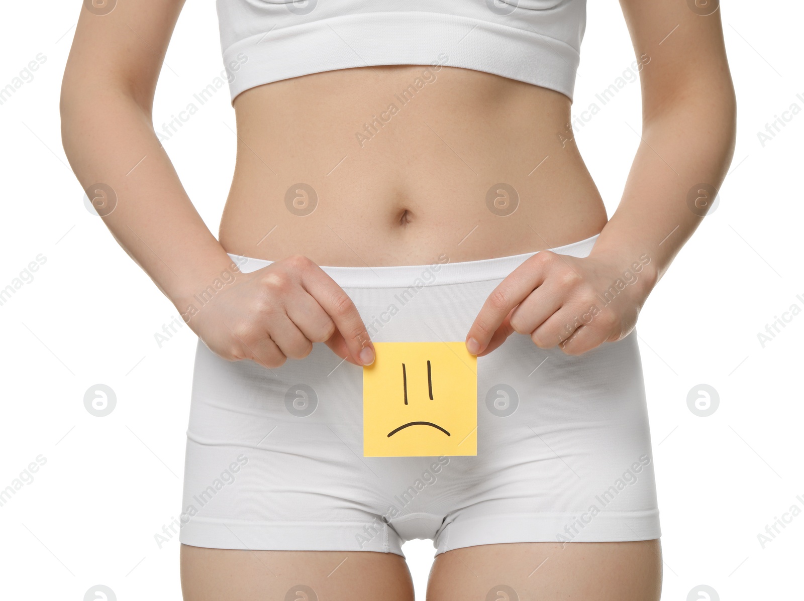 Photo of Cystitis. Woman holding sticky note with drawn sad face on white background, closeup