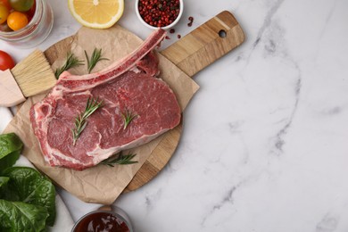 Photo of Flat lay composition with raw meat, rosemary and products on white marble table. Space for text