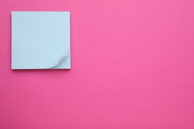 Empty notes on pink background, top view. Space for text