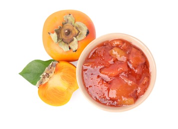 Bowl of tasty persimmon jam with fresh fruits on white background, top view