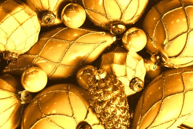 Many shiny golden Christmas tree baubles as background, closeup