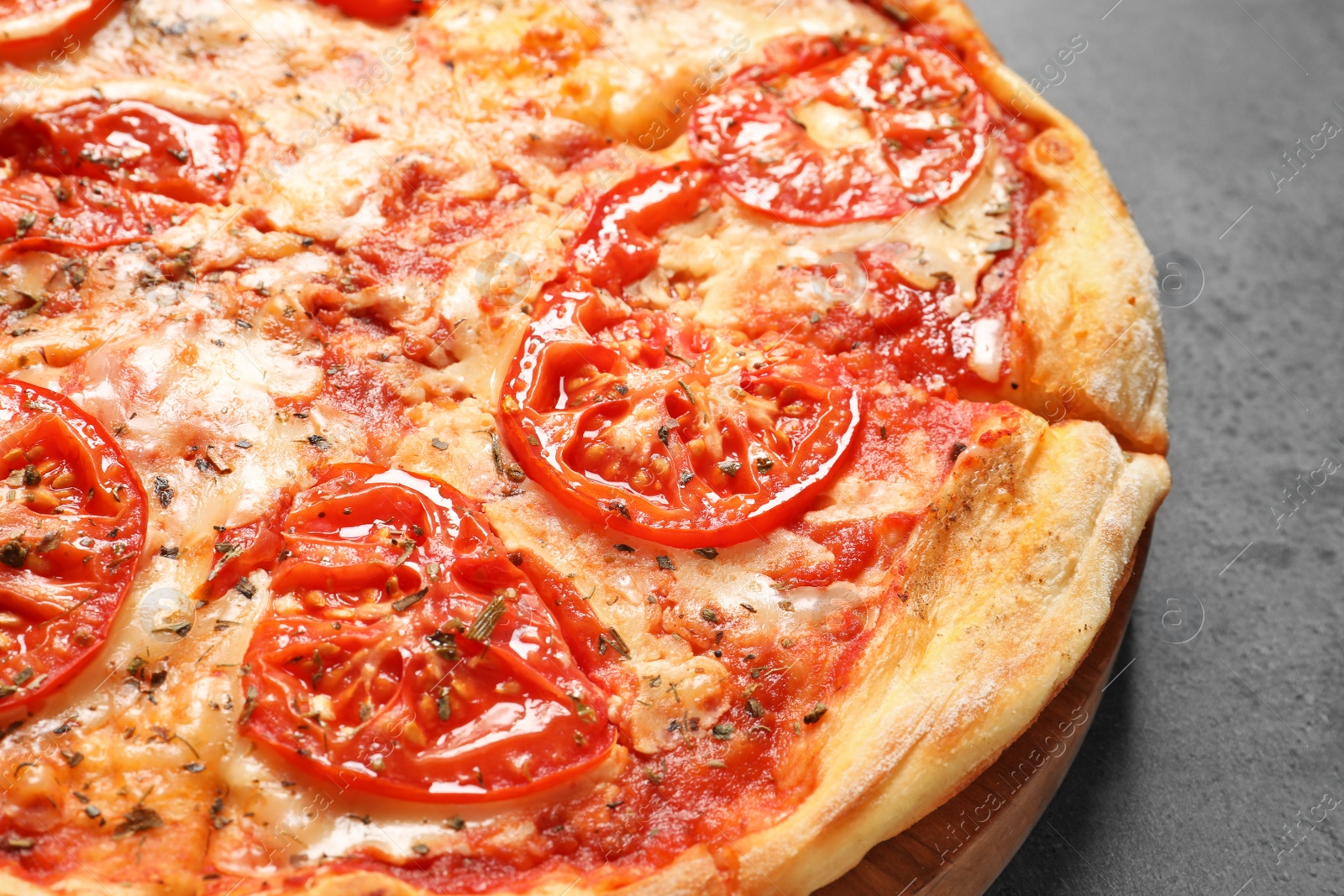 Photo of Hot cheese pizza Margherita on grey background, closeup