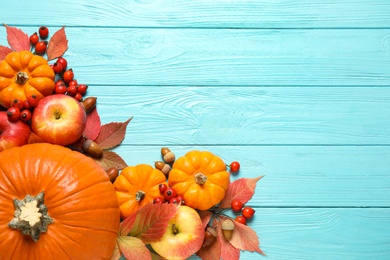 Photo of Flat lay composition with vegetables, fruits and autumn leaves on light blue wooden table, space for text. Thanksgiving Day
