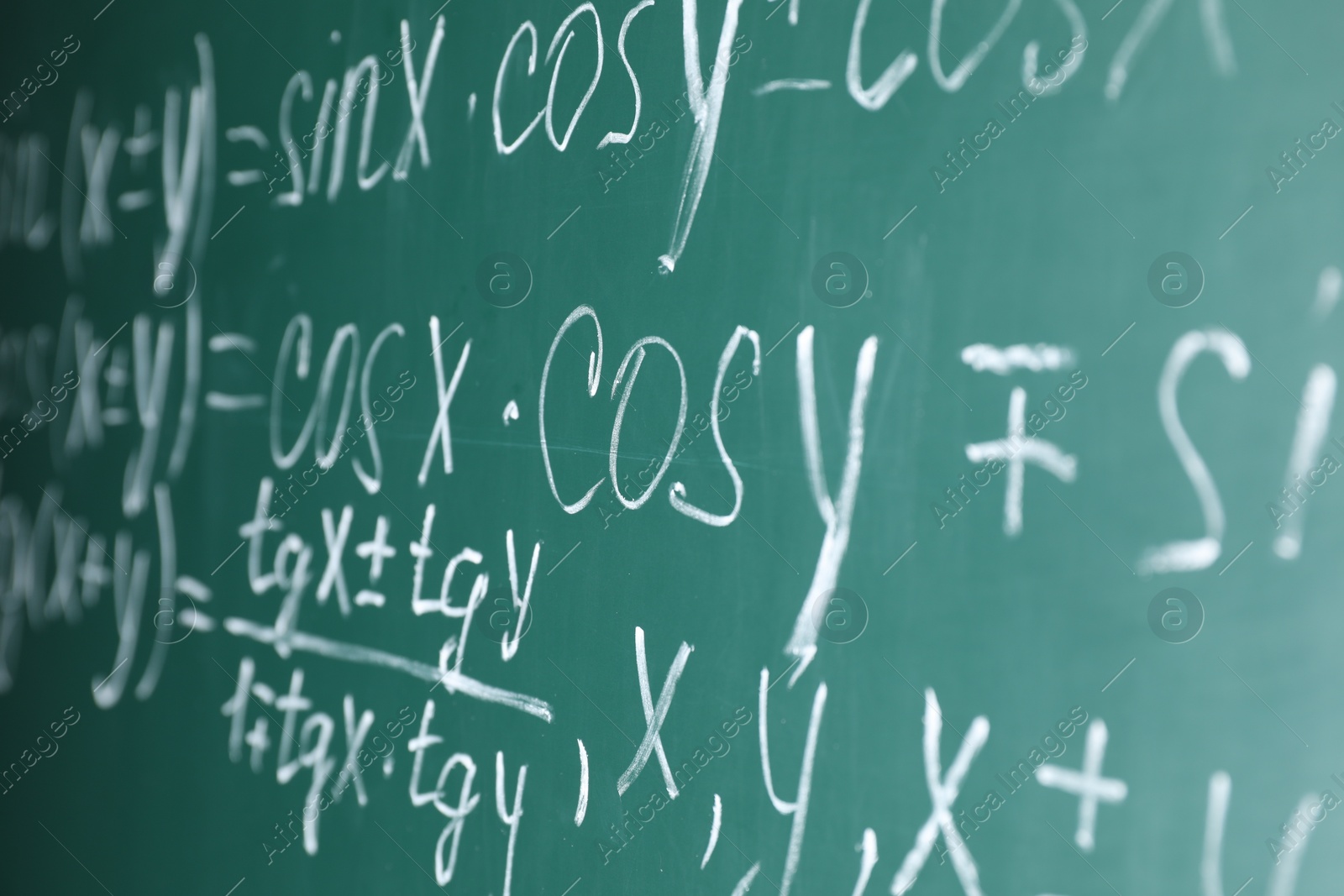 Photo of Many different math formulas written on chalkboard, closeup