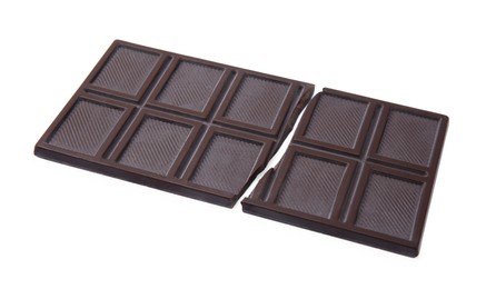 Photo of Broken dark chocolate bar on white background