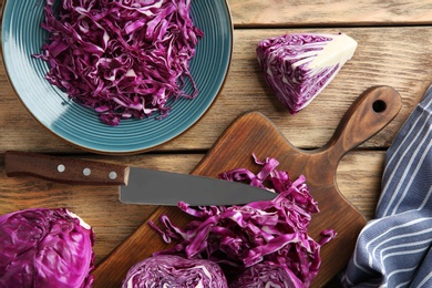 Flat lay composition with shredded red cabbage on wooden table