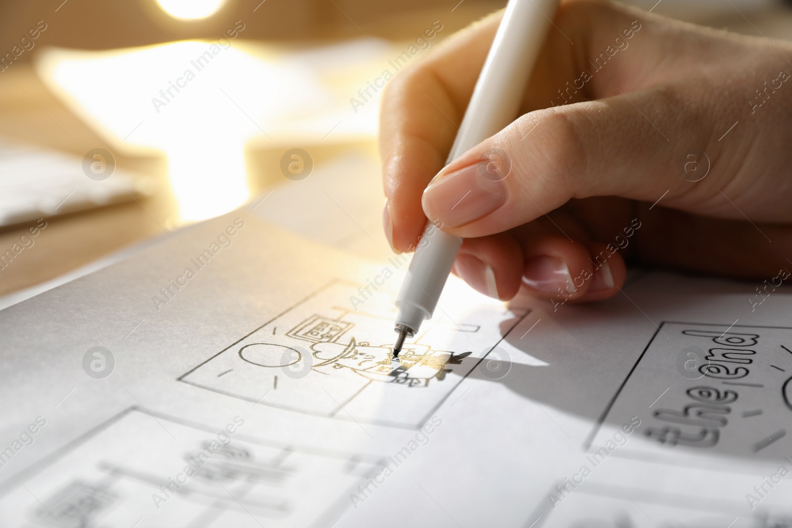 Photo of Woman drawing cartoon sketches at workplace, closeup. Pre-production process