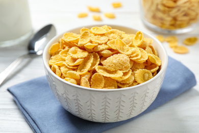 Photo of Tasty corn flakes on white wooden table