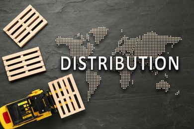 Distribution. Toy forklift and wooden pallets on black table, flat lay. Illustration of world map