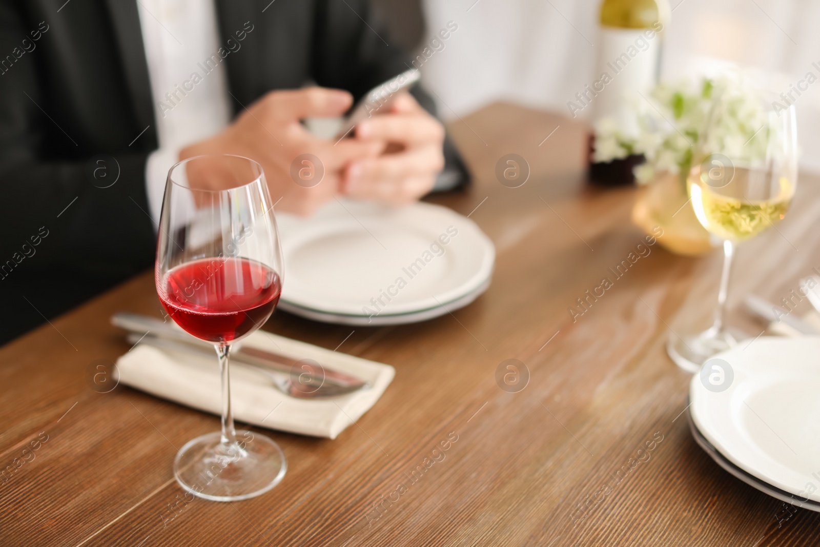 Photo of Man with glass of wine at table in restaurant