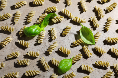 Photo of Uncooked garganelli pasta on grey table, flat lay