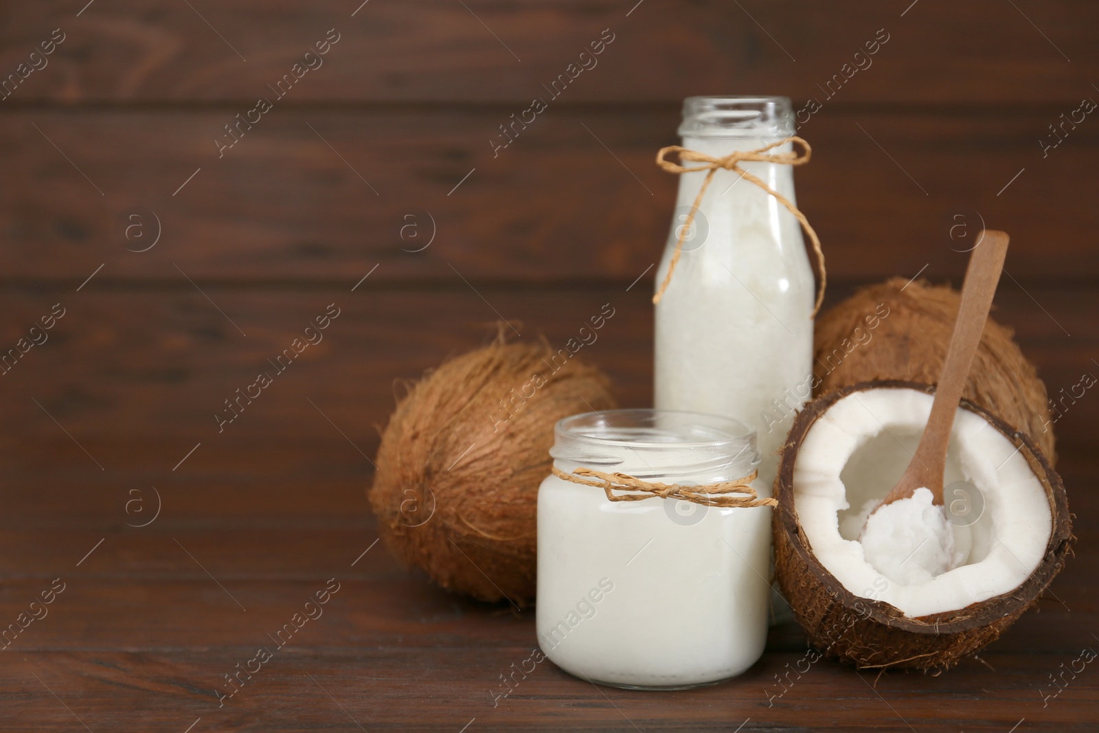 Photo of Composition with organic coconut oil on wooden table, space for text. Healthy cooking