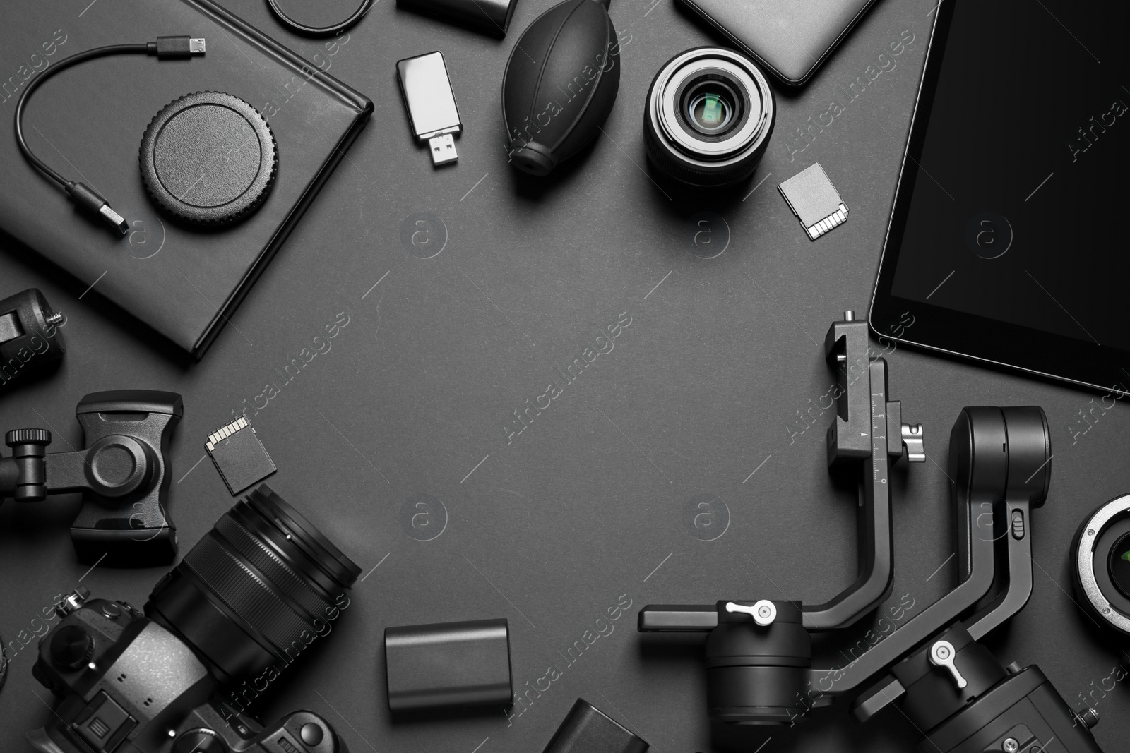 Photo of Camera and video production equipment on black background, flat lay. Space for text