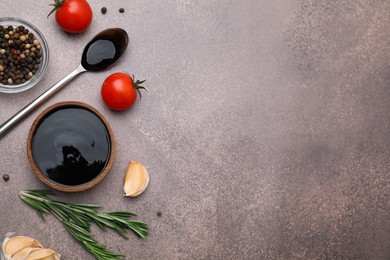 Photo of Organic balsamic vinegar and cooking ingredients on grey table, flat lay. Space for text