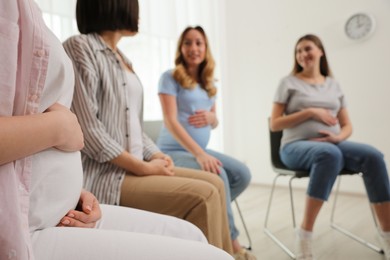 Photo of Group of pregnant women at courses for expectant mothers indoors, closeup