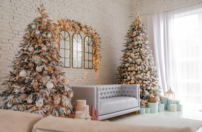 Beautiful interior of living room with decorated Christmas trees