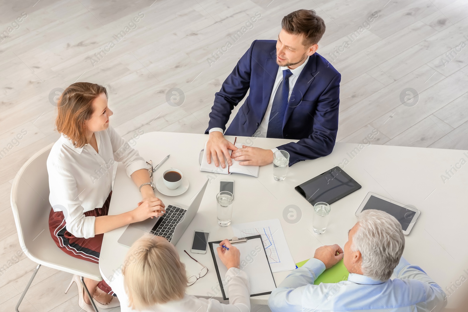 Photo of Group of people discussing ideas at table in office. Consulting service concept