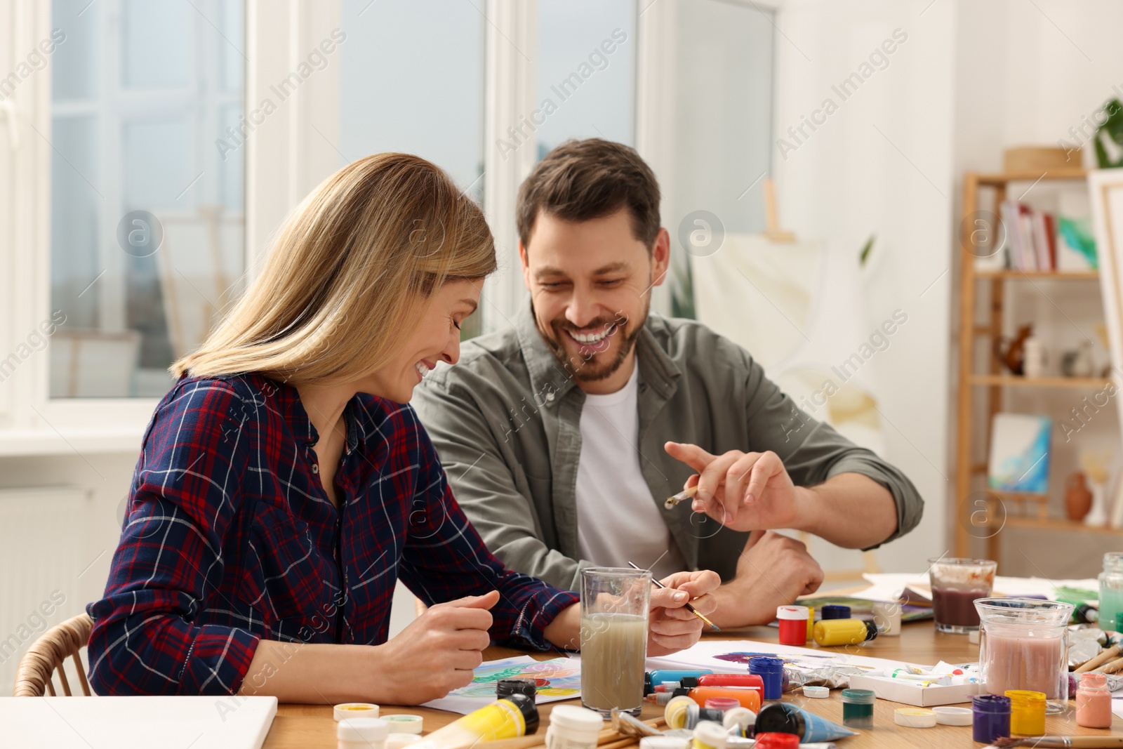 Photo of Students attending painting class in studio. Creative hobby