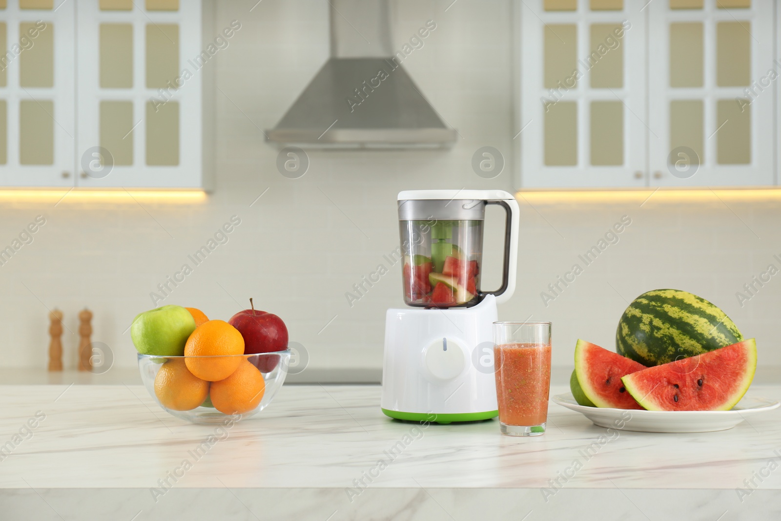 Photo of Blender and smoothie ingredients on table in kitchen