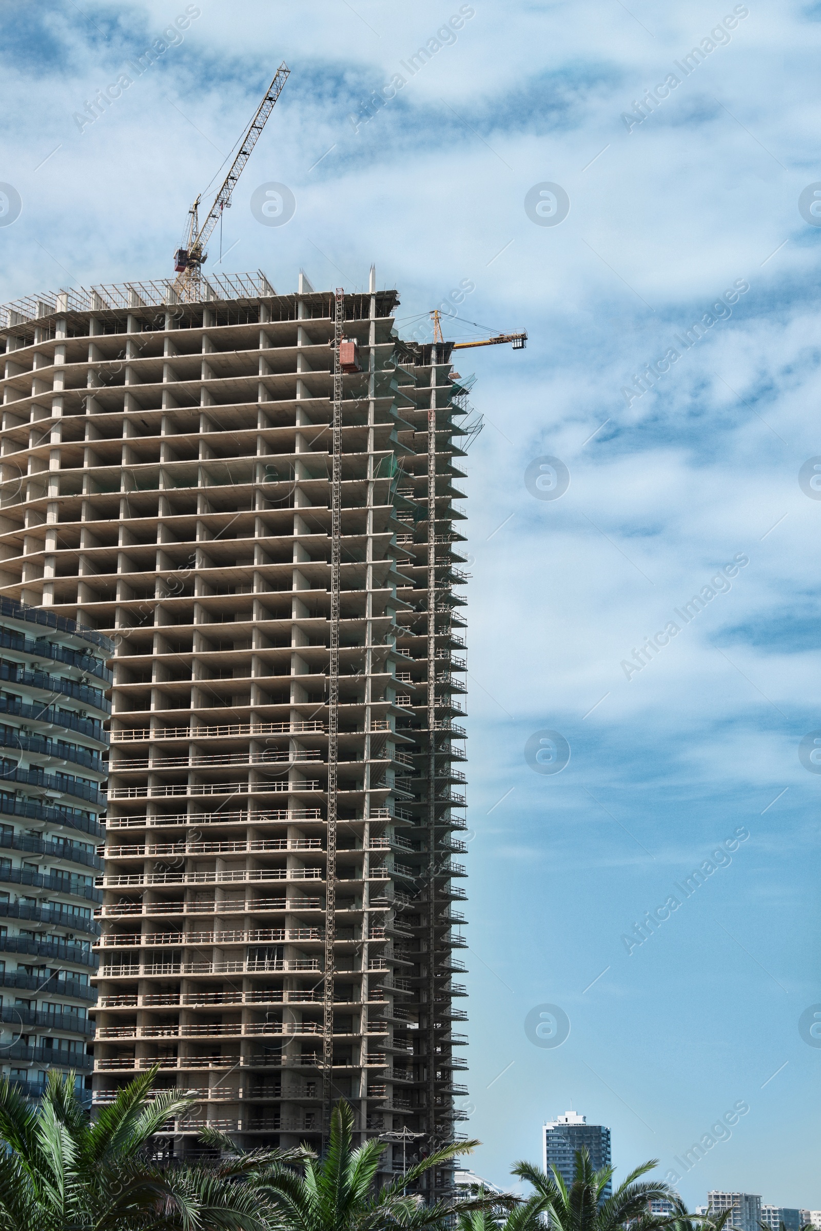 Photo of Construction site with tower crane near unfinished building