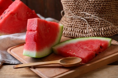 Photo of Sliced fresh juicy watermelon on wooden table