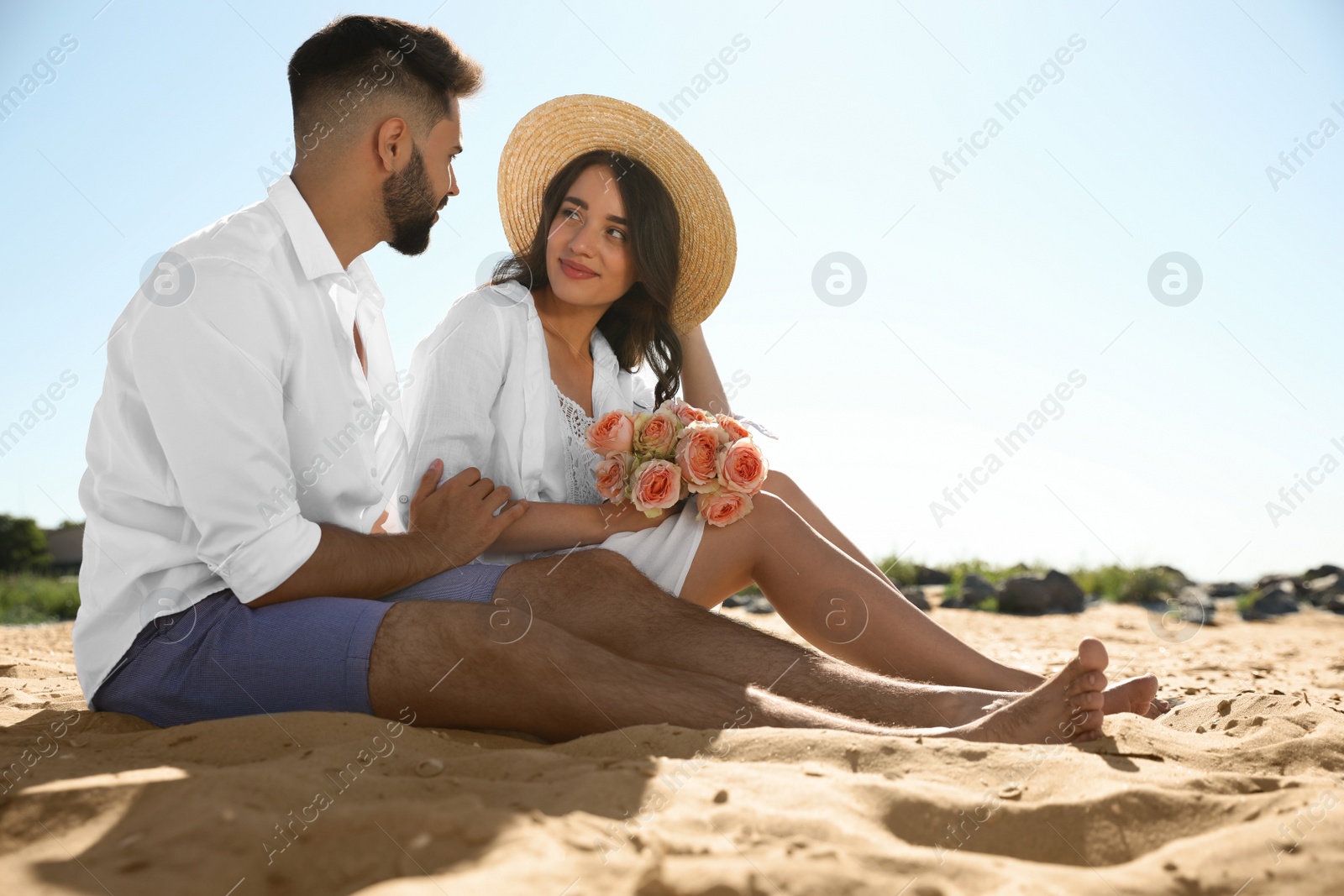 Photo of Happy young couple on beach. Honeymoon trip