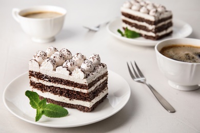 Photo of Composition with tiramisu cake and mint on table