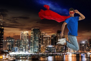 Image of Man wearing superhero costume and beautiful cityscape in night on background