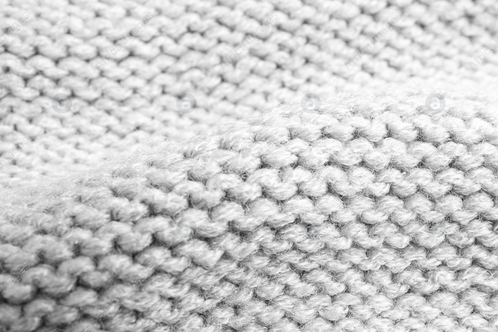 Photo of Grey knitted sweater as background, closeup view