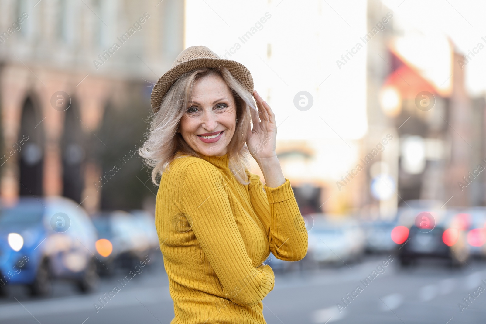 Photo of Portrait of happy mature woman on city street