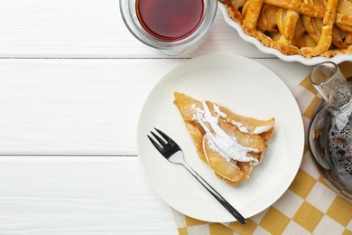 Piece of tasty homemade quince pie with powdered sugar served on white wooden table, flat lay. Space for text