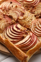 Tasty fresh apple galette on white wooden table, closeup