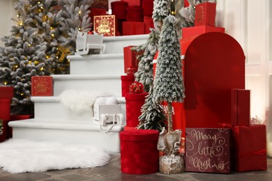 Christmas tree, gift boxes and festive decor indoors. Interior design