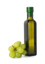 Photo of Vegetable fats. Bottle of cooking oil and fresh grapes isolated on white