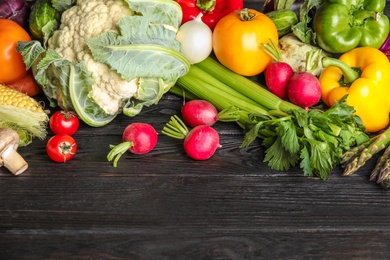 Photo of Flat lay composition with assortment of fresh vegetables on wooden table. Space for text