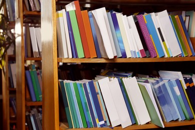 Collection of different books on shelves in library