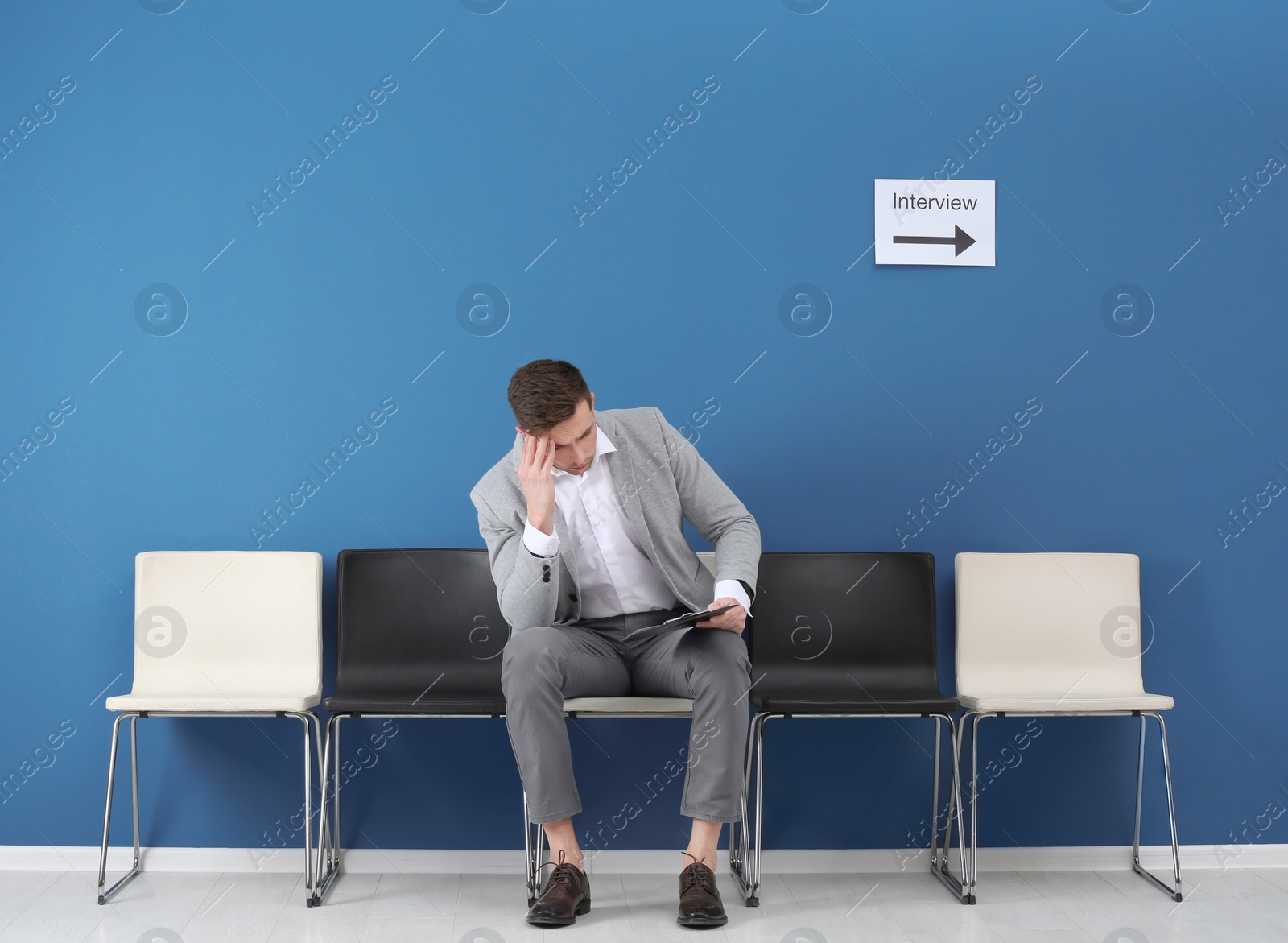 Photo of Young man waiting for job interview, indoors