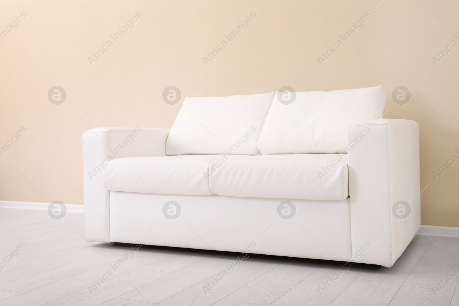 Photo of Room interior with comfortable sofa near color wall